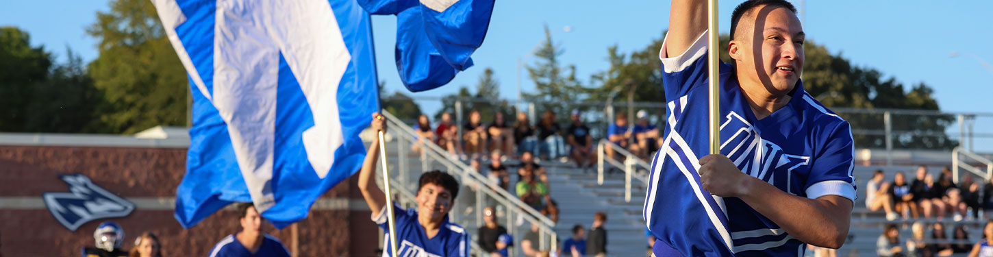 A student holds a vial in a gloved hand