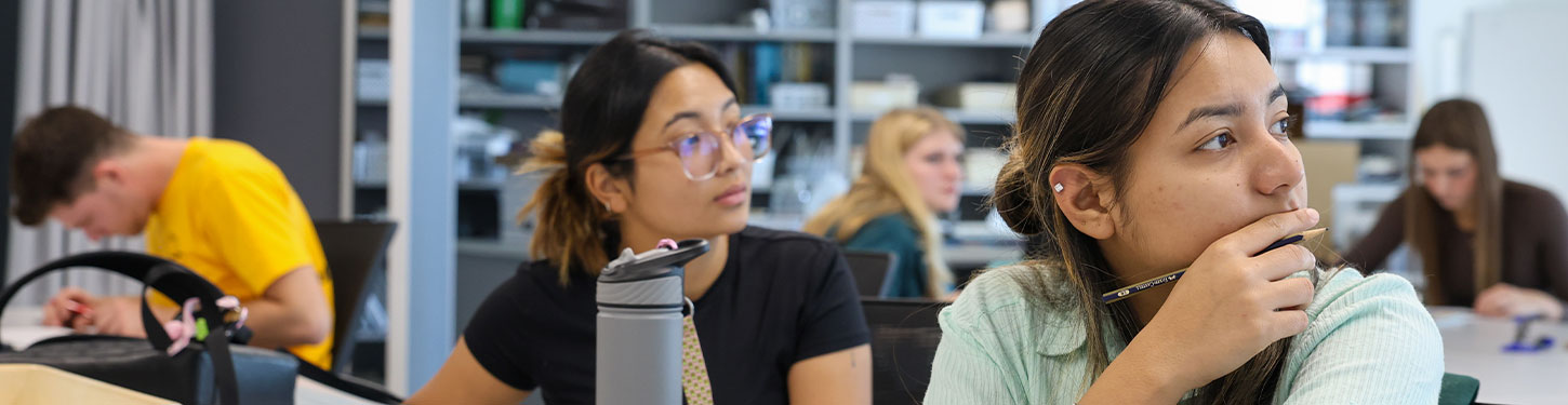 a faculty member helping a student with a video project