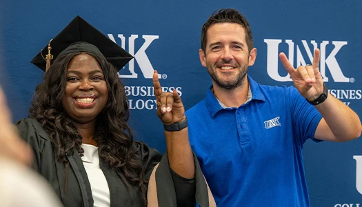 Elizabeth Ama Baidoo and dustin favinger throw the lopes at graduation