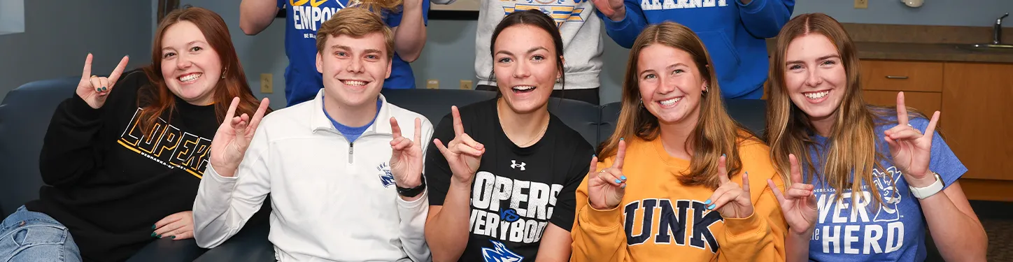 students pose together on a couch