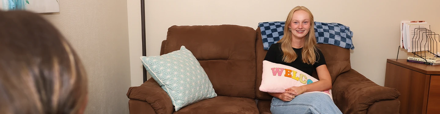 a student sits on a couch in a counseling session