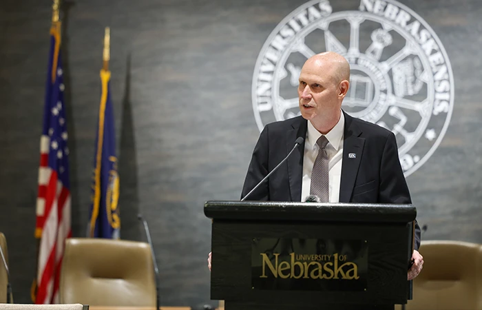 chancellor schnoor speaks at a podium
