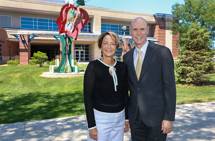 Neal and Teresa Schnoor outside the college of education building