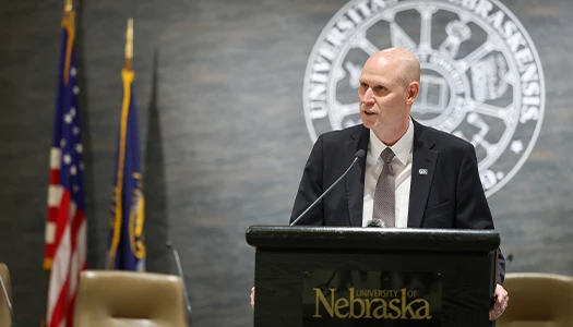 Chancellor schnoor speaks at a podium