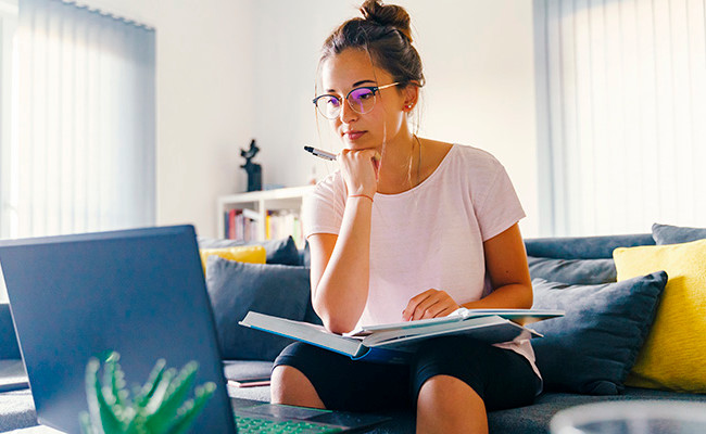 A woman looks at a laptop