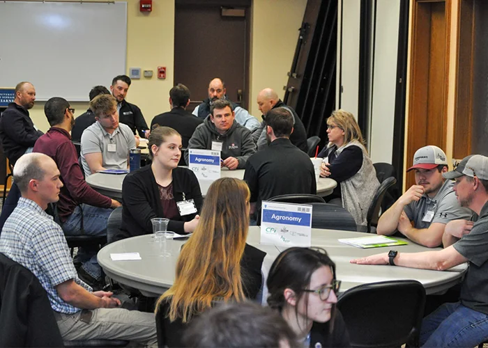 students sit and discuss at a roundtable event