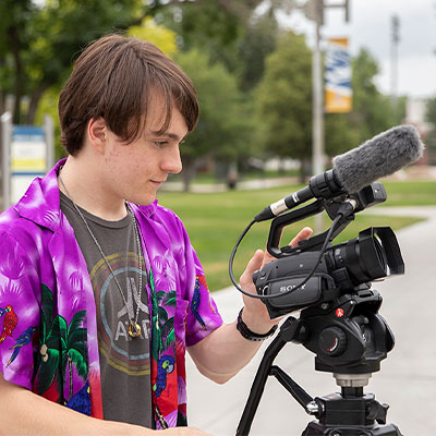 a student operates a video camera