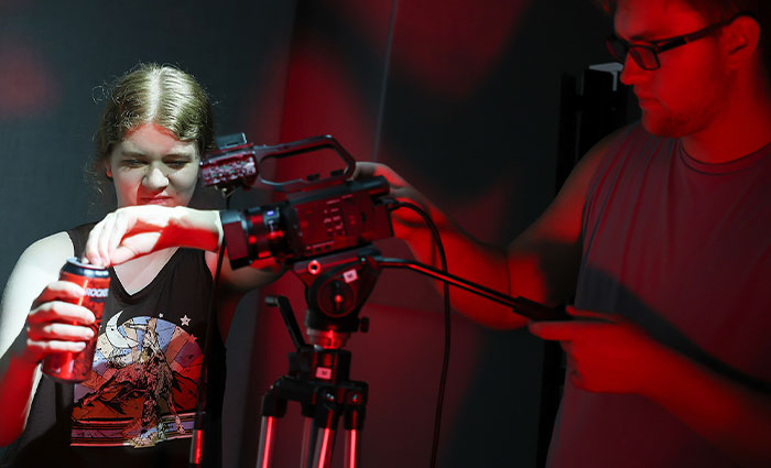 students use a camera to take a photo of a drink
