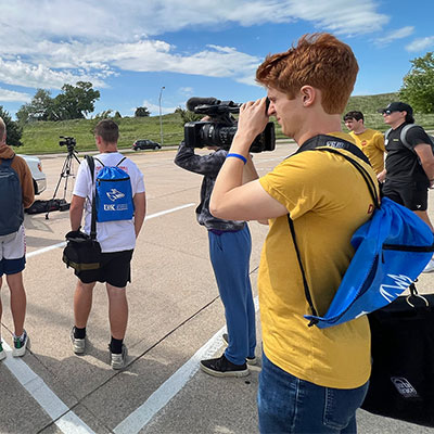 a student looks through a video camera