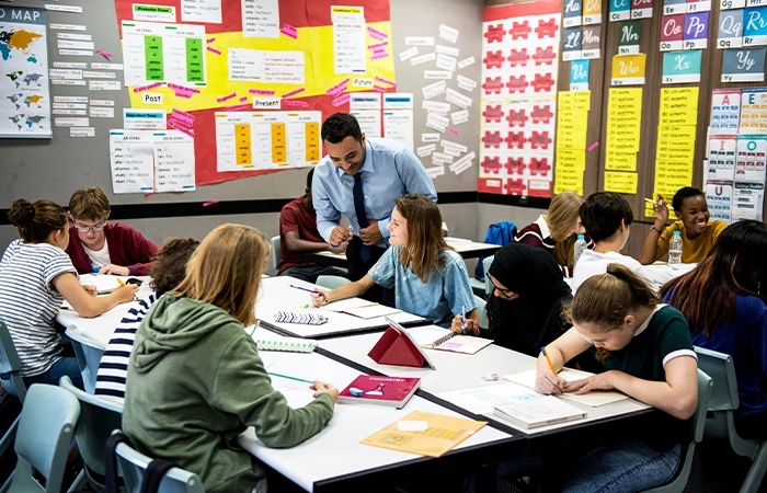 a teacher working with students in a classroom