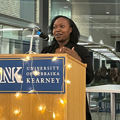 a woman speaks at a podium