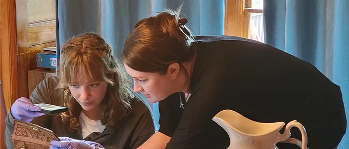 a student and instructor catalog items at a museum