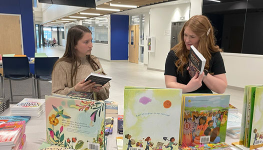 Student browse books on a table