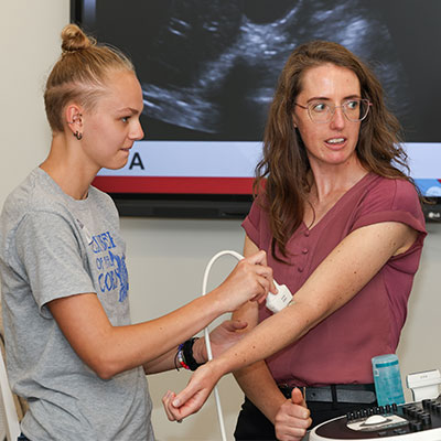 a student uses medical equipment during a demonstration