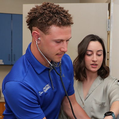 a student wears a stethoscope