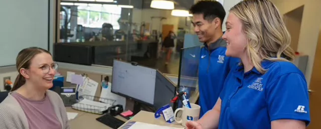 students and staff interact at a welcome desk