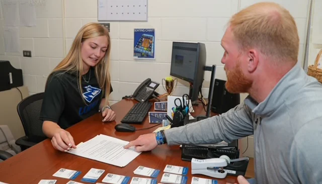 student and staff sorting tickets
