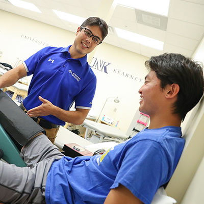 a student works with a patient in a clinical setting