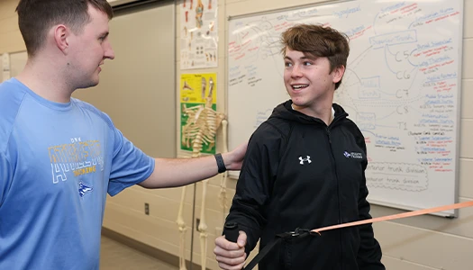 a student works with a patient at a clinic