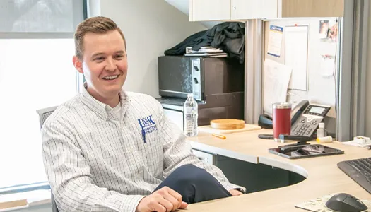 Mitch Peters sits at his desk