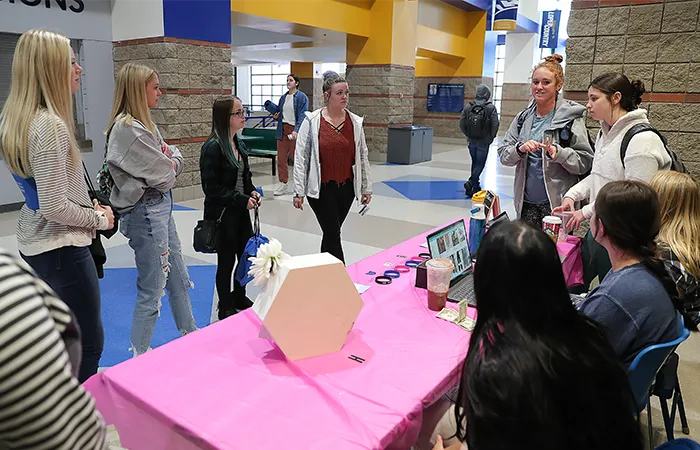 a tour guide and campus tour group at a table