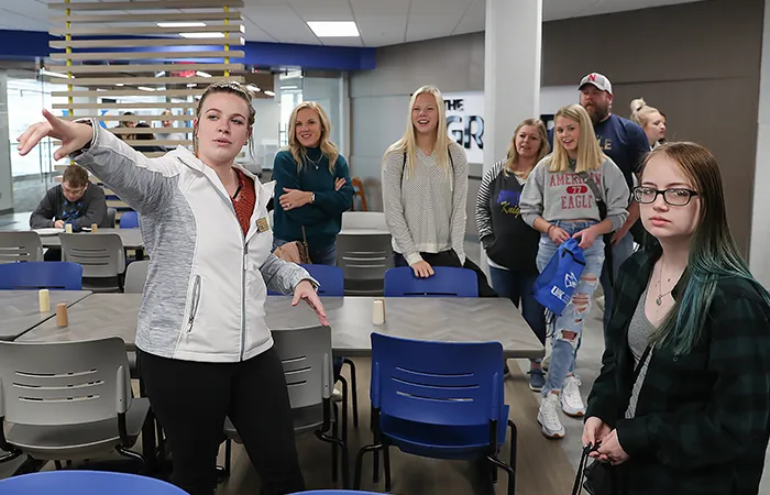 a tour guide points out areas of the main unk cafeteria