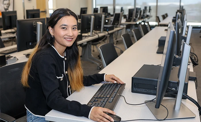 unk student Purnima Maharjan poses for a photo in a computer lab
