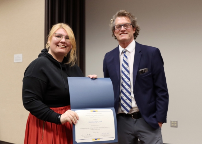 Man presenting a woman an award.