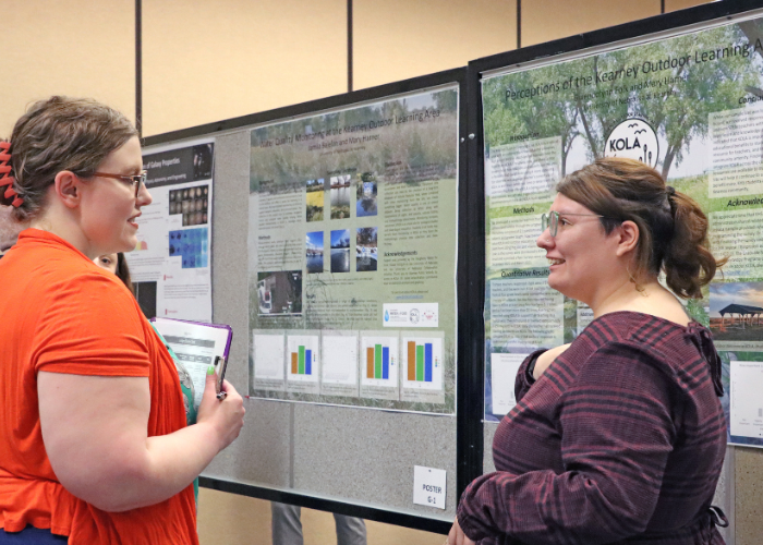 Woman presenting research to judges.