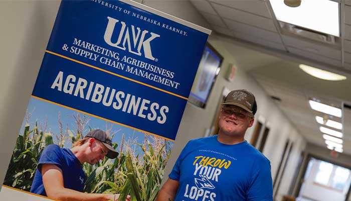 Bumgarner in front of Agbusiness sign