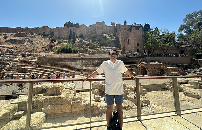 Man in front of castle in Spain.