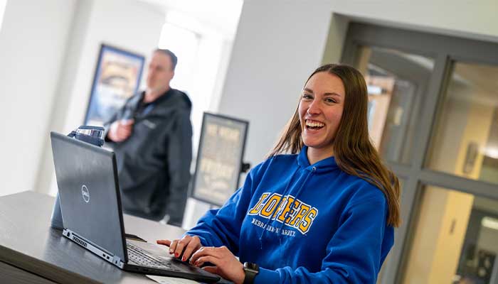 Cassidy at the welcome desk greeting