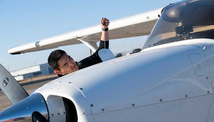Yu inspecting airplane