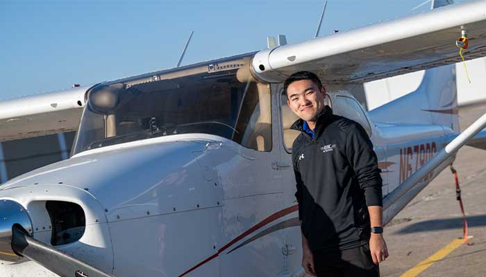 Yu standing in front of Cesna