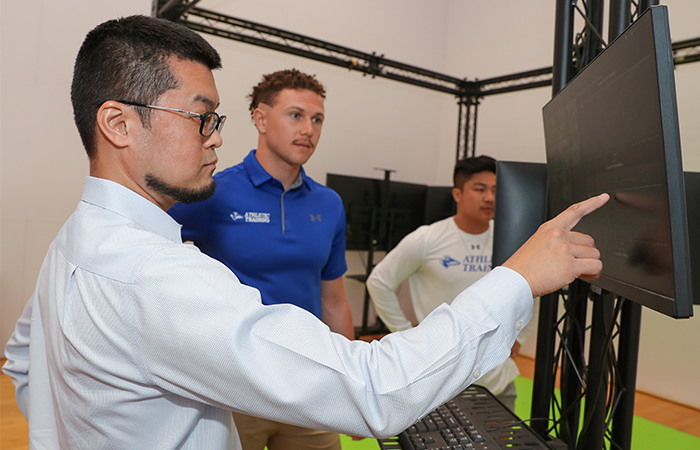 MAT professor works with two students on state-of-the-art technology.