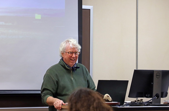 Rick Brown laughing at front of classroom.