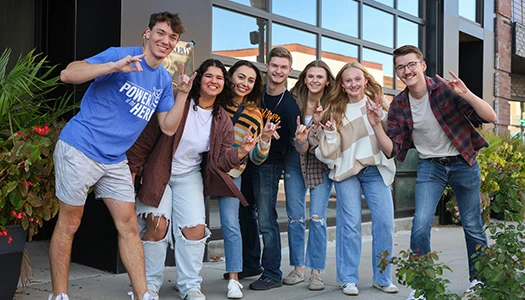 a group of student pose for a photo in downtown kearney