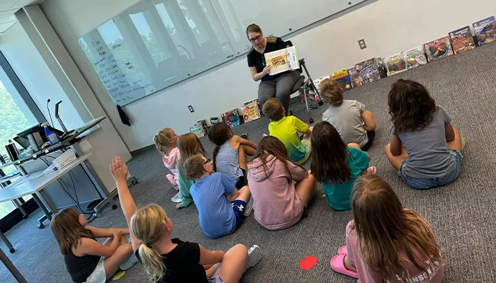 an instructor reads to a classroom full of students