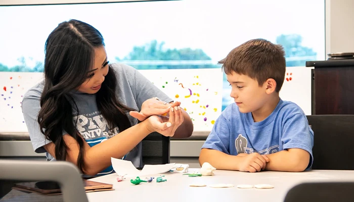 a student works with an instructor in a classroom