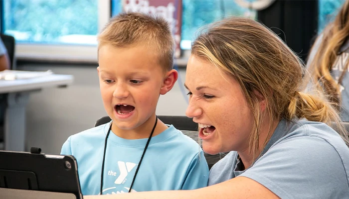 a student and instructor work together with an ipad