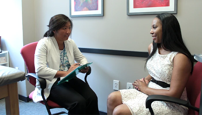 a woman talks with a healthcare professional in an office