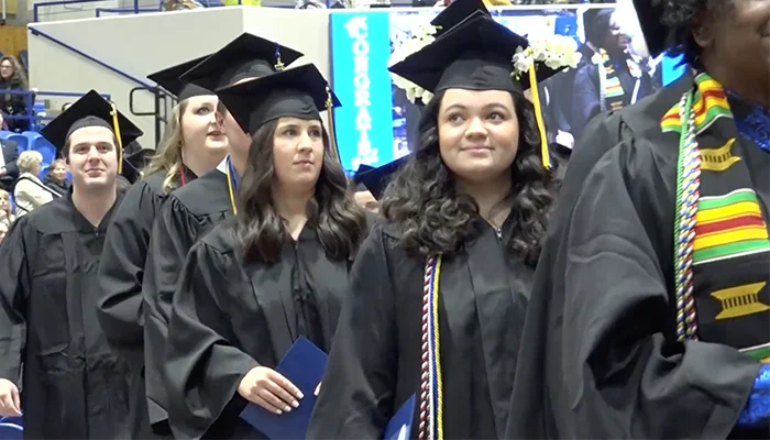 a student walks at graduation