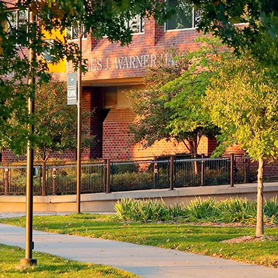 an exterior shot of warner hall on a sunny fall day