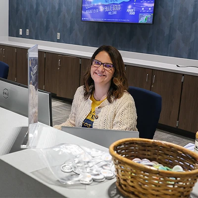 a staff member sits at a counter