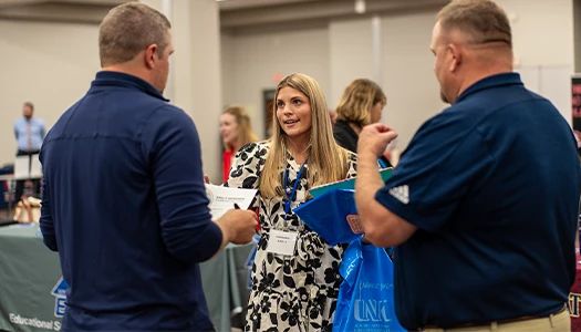 a student talks with recruiters at a job fair