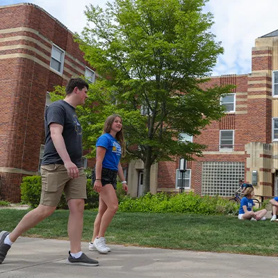 students walk across campus