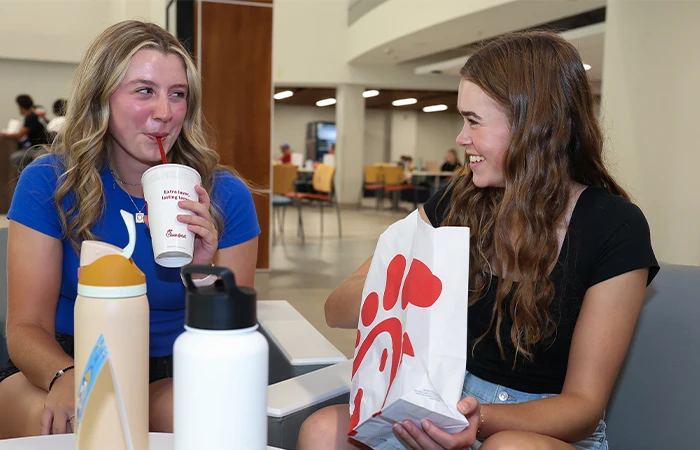 students sit enjoying chick fil a
