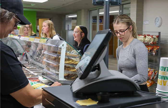 students check out at subway