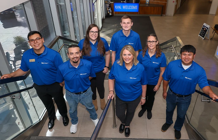 The SEL staff pose for a group photo on a set of stairs in the student union