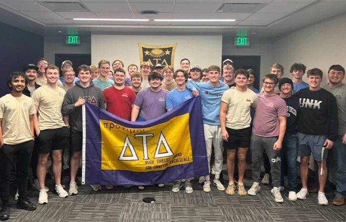members of delta tau delta pose for a photo